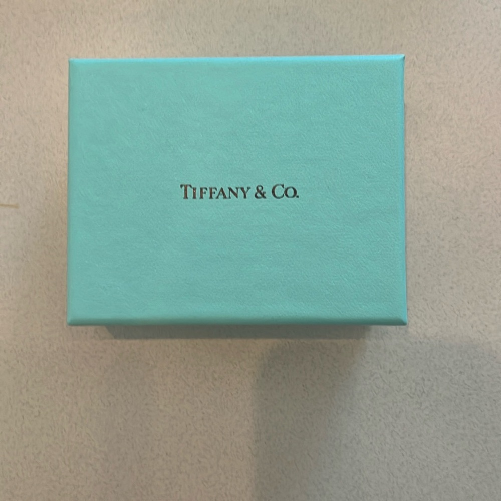 Tiffany & Co small box with white and red ribbons.
